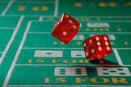 dice being thrown on craps table